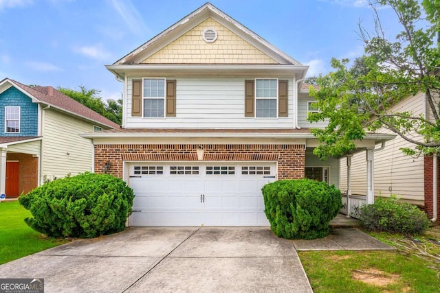 view of front of house with driveway, a garage, and brick siding