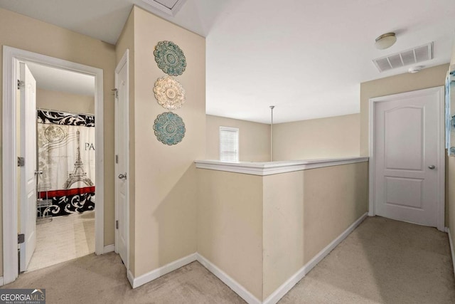 hall featuring visible vents, carpet, an upstairs landing, and baseboards