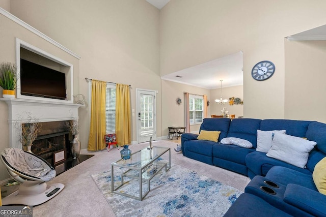 living room with carpet floors, a fireplace with flush hearth, a towering ceiling, baseboards, and an inviting chandelier