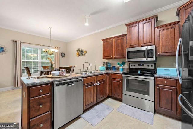 kitchen featuring a peninsula, crown molding, appliances with stainless steel finishes, and a sink