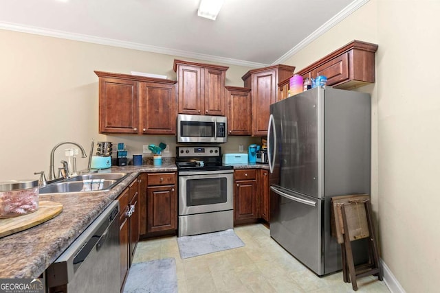 kitchen with baseboards, appliances with stainless steel finishes, a sink, and ornamental molding