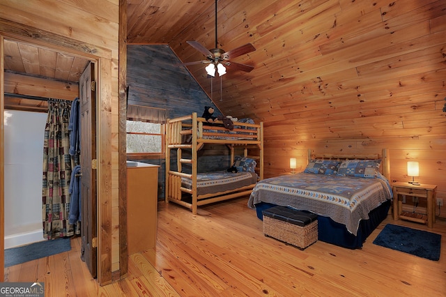 bedroom featuring wooden ceiling, vaulted ceiling, wooden walls, and hardwood / wood-style floors