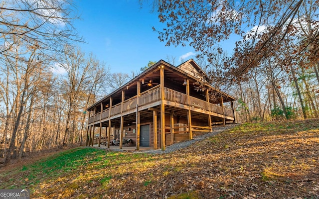 back of house featuring a patio area and a wooden deck