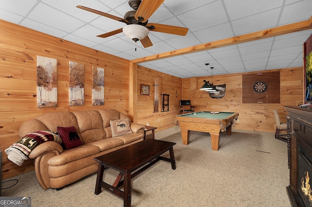 rec room with ceiling fan, a paneled ceiling, wooden walls, billiards, and carpet
