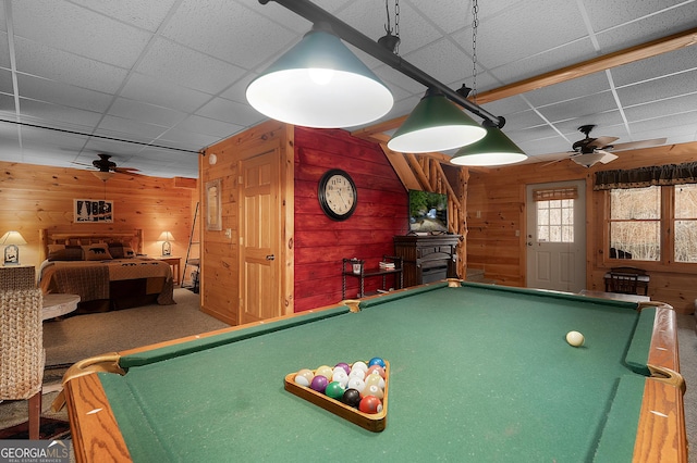 game room featuring a paneled ceiling, pool table, wood walls, and ceiling fan