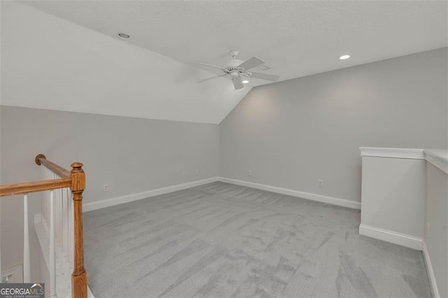 additional living space with carpet floors, recessed lighting, vaulted ceiling, ceiling fan, and baseboards