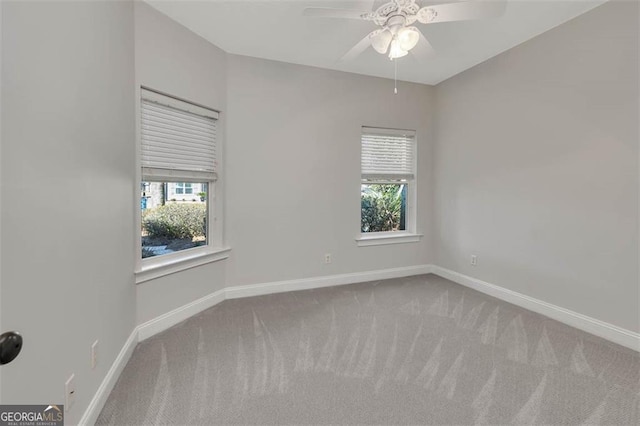 spare room with carpet floors, baseboards, and a ceiling fan