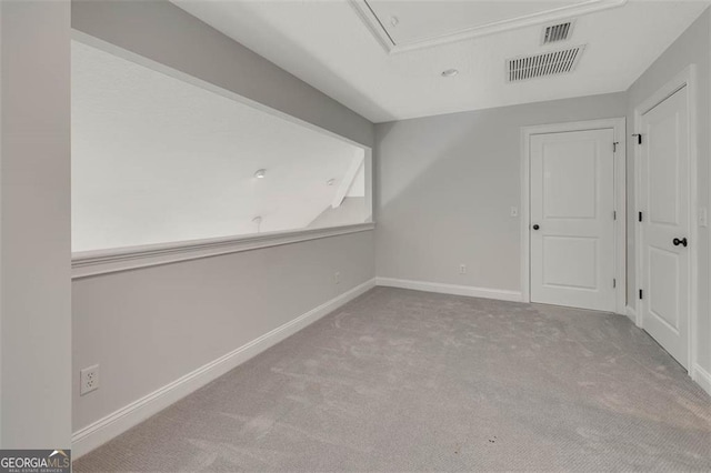 bonus room featuring attic access, baseboards, visible vents, and carpet flooring