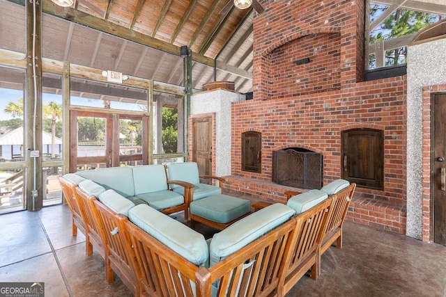 interior space featuring vaulted ceiling with beams, french doors, a brick fireplace, and wooden ceiling