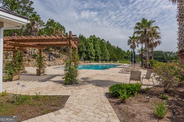 community pool with a patio and a pergola