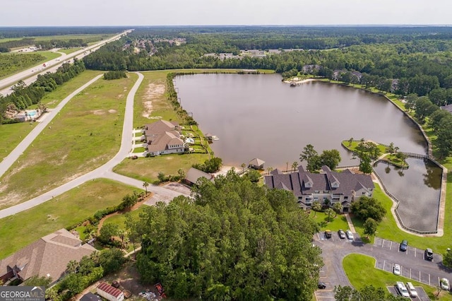 birds eye view of property with a water view and a view of trees