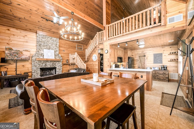 dining room with visible vents, wood walls, and wood ceiling