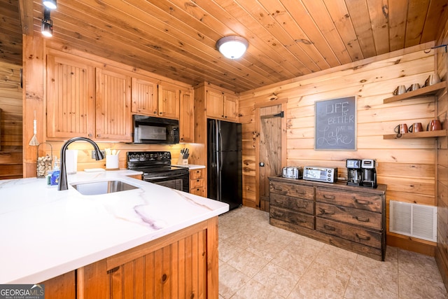 kitchen featuring black appliances, wood ceiling, visible vents, and a sink