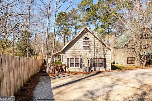 rear view of house featuring fence