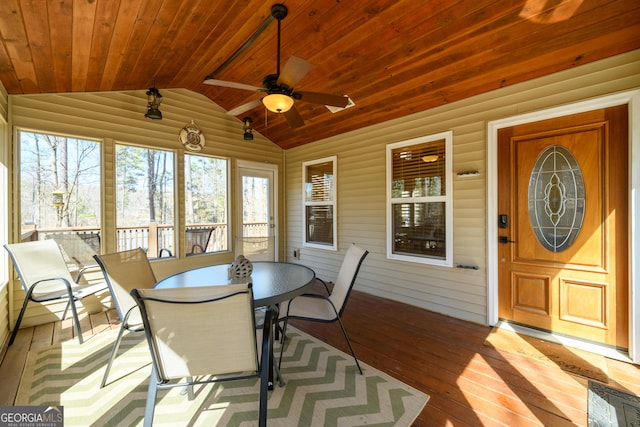 sunroom / solarium featuring lofted ceiling, wood ceiling, and ceiling fan