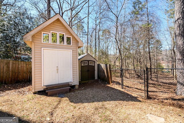 view of shed with fence private yard and a gate