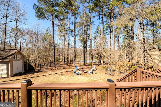 view of yard featuring an outdoor structure, fence, and a storage unit