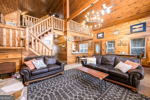 living area with wooden ceiling, wood walls, and ceiling fan with notable chandelier