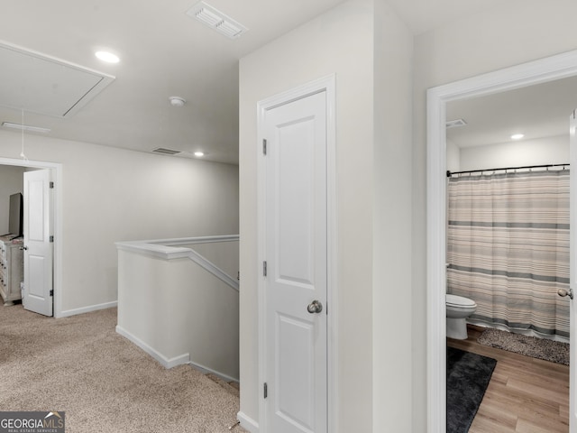 hall featuring recessed lighting, visible vents, attic access, an upstairs landing, and baseboards