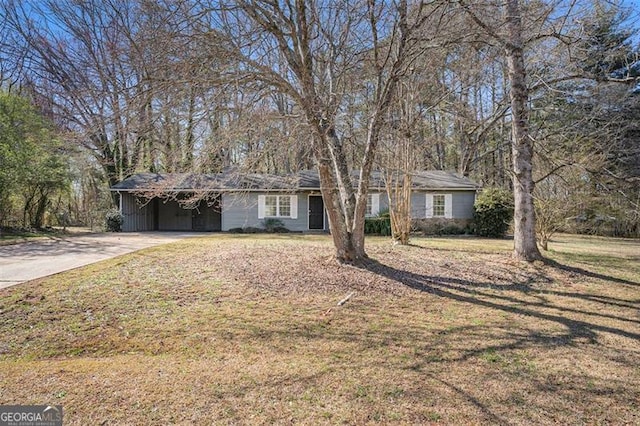 single story home with a carport, driveway, and a front lawn