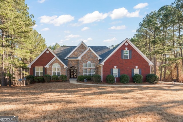 view of front facade with a front yard and brick siding