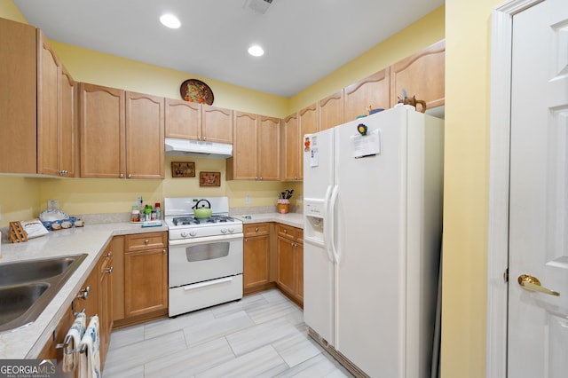 kitchen featuring under cabinet range hood, light countertops, recessed lighting, white appliances, and a sink