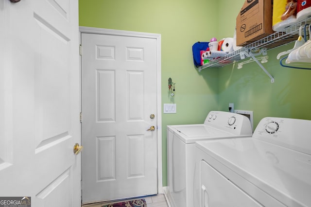 clothes washing area with separate washer and dryer and laundry area