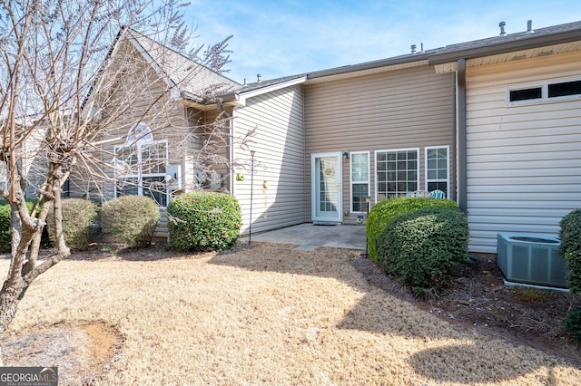 back of property with cooling unit and a patio