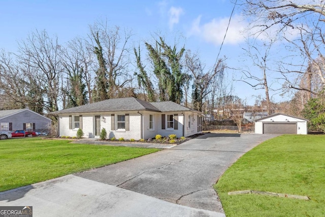 single story home with a front yard, brick siding, a detached garage, and an outdoor structure