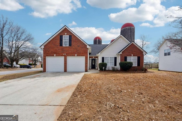 traditional home featuring an attached garage, fence, concrete driveway, and brick siding