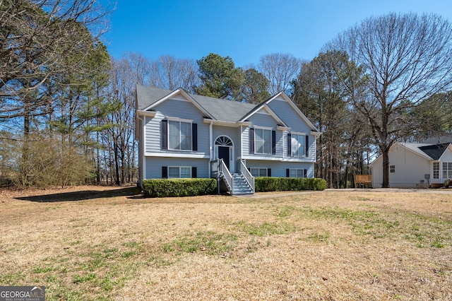 raised ranch with a front lawn