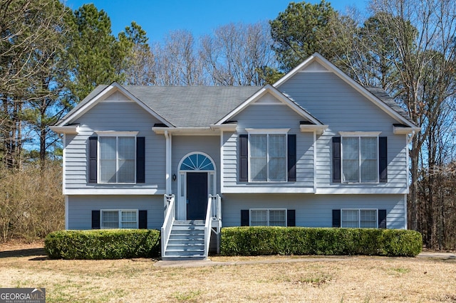 raised ranch with a front lawn