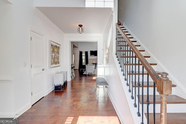 entrance foyer with wood-type flooring, stairs, and baseboards