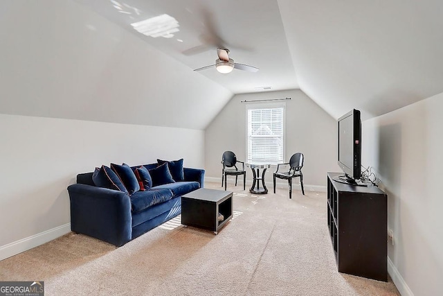 living room with vaulted ceiling, light colored carpet, and baseboards