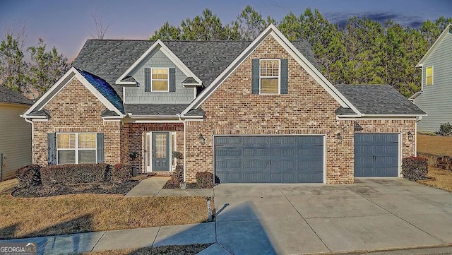 view of front of home with driveway, roof with shingles, an attached garage, and brick siding