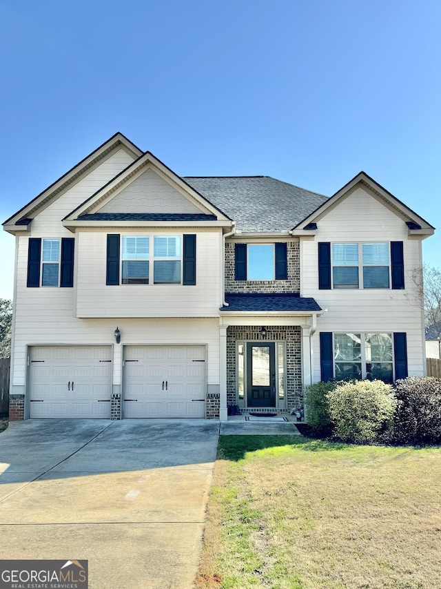 view of front of property with driveway, roof with shingles, an attached garage, a front lawn, and brick siding