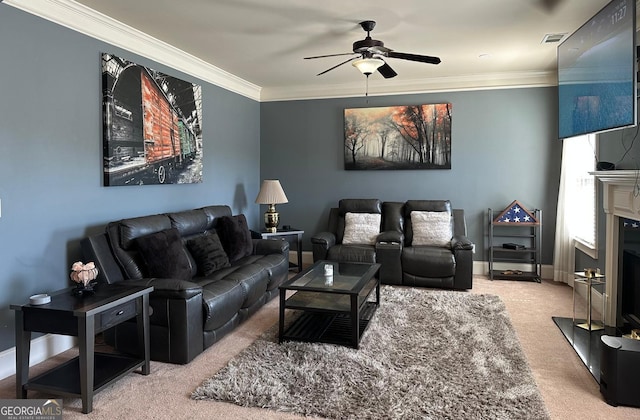 living room with baseboards, visible vents, ceiling fan, crown molding, and a fireplace