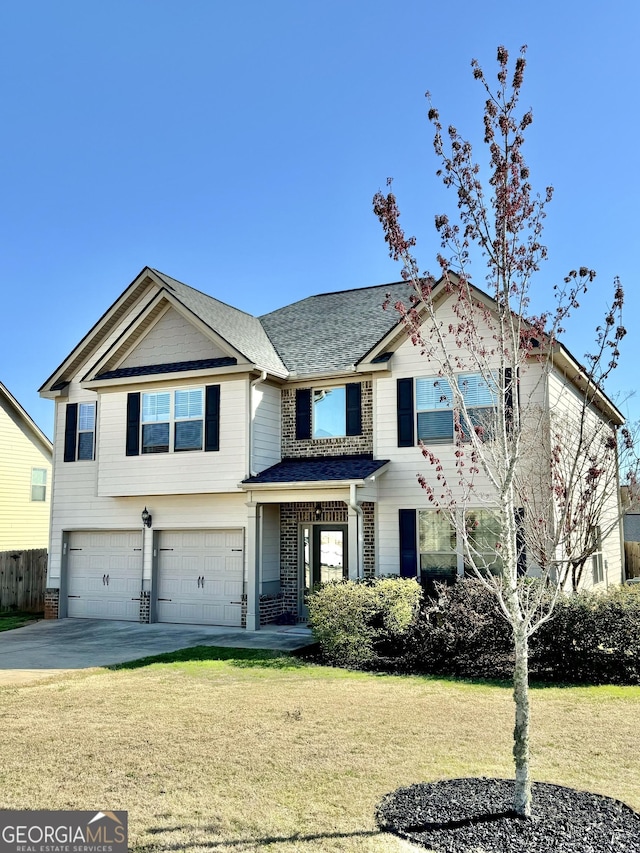 view of front facade with concrete driveway, an attached garage, fence, a front yard, and brick siding