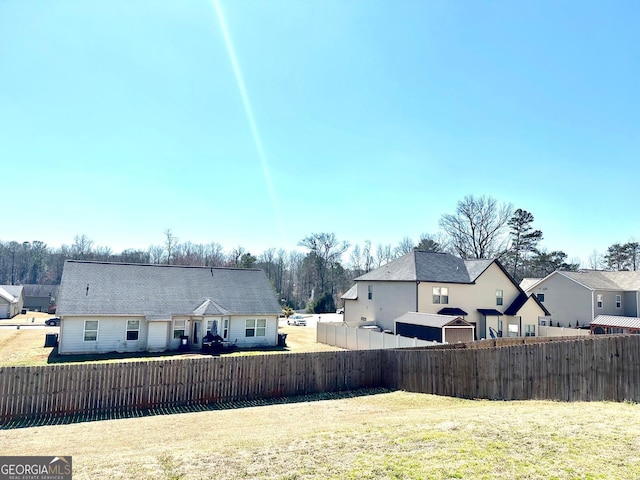 view of yard with a residential view and fence