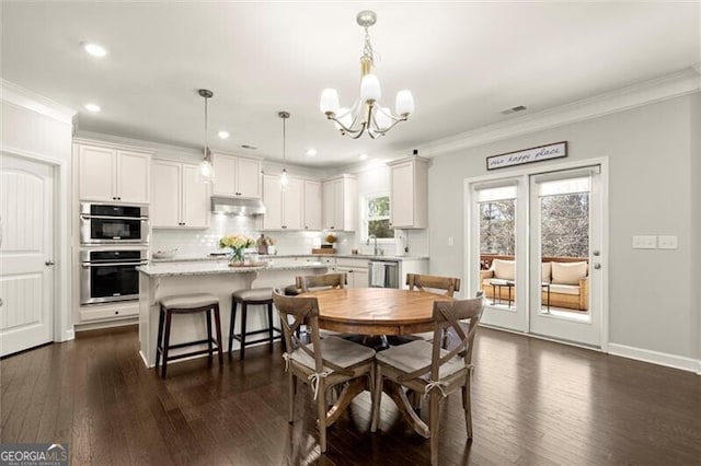 dining area with a notable chandelier, baseboards, dark wood-style flooring, and crown molding