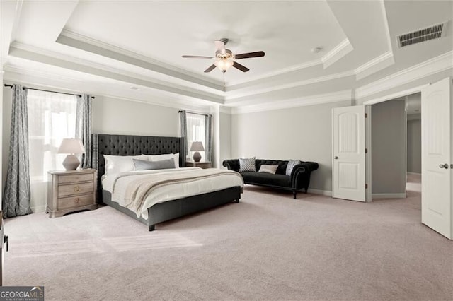 bedroom featuring visible vents, a raised ceiling, baseboards, ceiling fan, and carpet