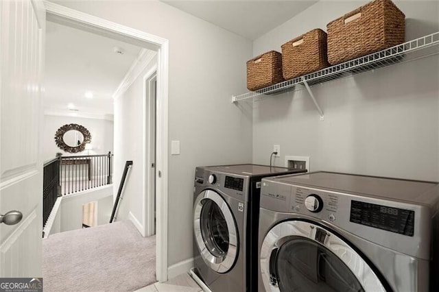 washroom with laundry area, tile patterned flooring, baseboards, and washer and dryer