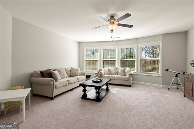 living area with carpet floors, ceiling fan, and baseboards