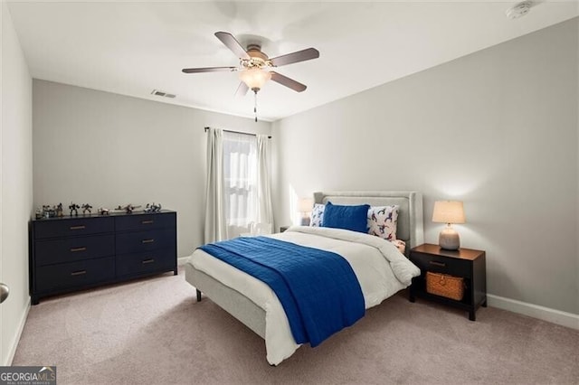 bedroom featuring a ceiling fan, light colored carpet, visible vents, and baseboards