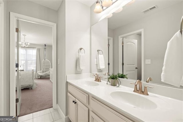 bathroom featuring double vanity, visible vents, a sink, and ensuite bathroom