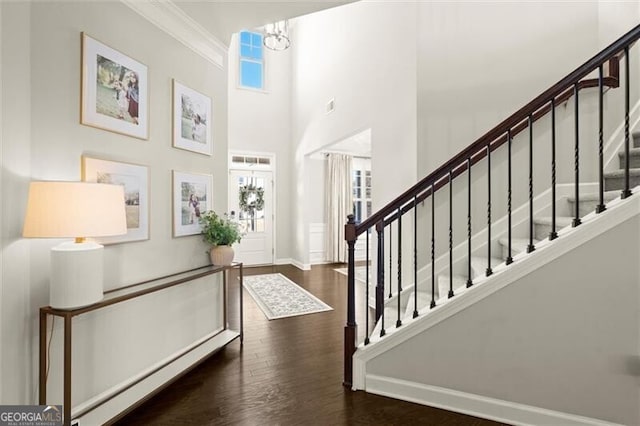 entryway featuring visible vents, stairs, baseboards, and dark wood finished floors