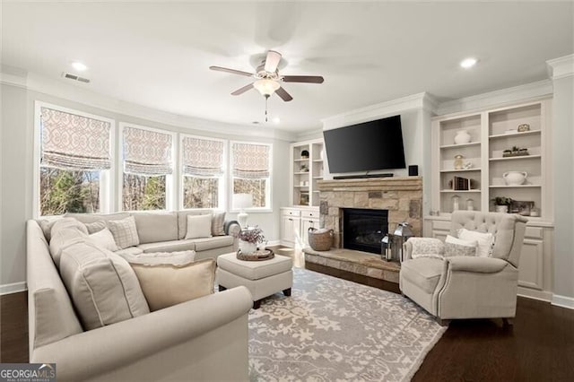 living room featuring dark wood-style flooring, a healthy amount of sunlight, and crown molding