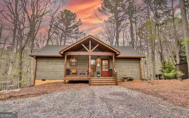 view of front of property featuring a shingled roof, crawl space, and a porch