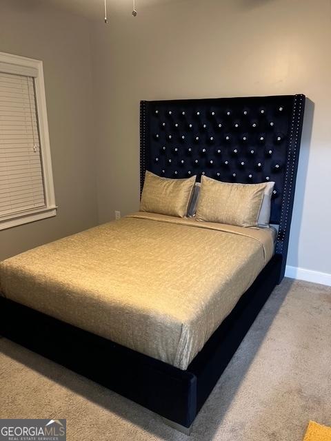 bedroom with carpet floors and baseboards