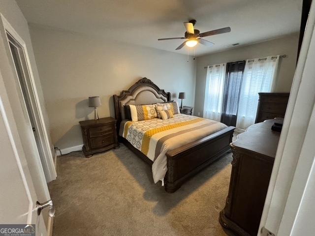 bedroom with carpet and a ceiling fan